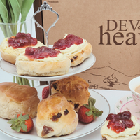 Fruit & Plain Scone Cream Tea, close up of scones with cream and jam displayed on cake stand.